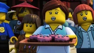 Ninjago citizens with a tray of cake.