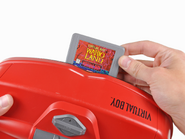 A Virtual Boy Wario Land cartridge being inserted into a Virtual Boy