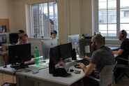 A photo of some of Nitrome's employees working at Nitrome Towers seen from the inside.