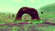 An arch made of Iridium on the surface of a planet.