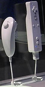 The Nunchuk (left) plugged into a pre-release model of the Wii Remote, as shown at E3 2006.