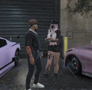 Emeka Rose, wearing a cop costume for the Halloween season, and Louis Blanc chat before a night race. October 2025