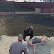 Raymond Romanov beside Hannah while receiving help from EMS, after being shot.