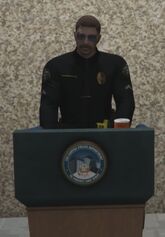 Flop speaks at the meeting