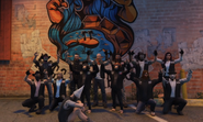 HOA taking a photo beside their mural