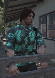 Kody is dressed in a neon-ish blue floral hawaiian shirt and black pants with a radio mounted on his shoulder and belt.