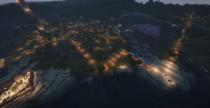 An expansive view of the Melonanarchy spawn area as of August 2024, featuring the Shovel Society headquarters with two icons above the buildings. The area includes various trees, including pink cherry trees, and several farms. The scene is well-lit, showcasing the detailed design and vibrant community space.