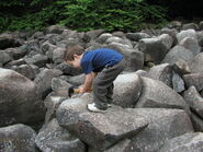 A child striking one of the rocks