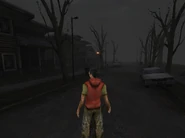 A very detailed street with houses, street lamps, trash cans, cars...