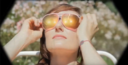 Woman putting on second pair of sunglasses S0E0