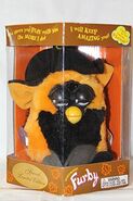 A boxed Autumn Furby with closed eyes