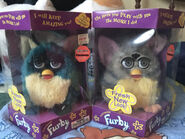 A boxed Fresh Dragon Furby and a boxed Sunrise Furby
