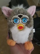 A 2001 Church Mouse Furby with neon blue eyes