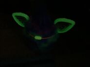 The backside of the Furby while glowing