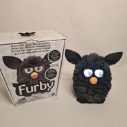 A Black Magic furby with the Scandinavian box.