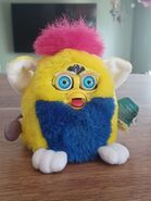 Primary Furby baby with neon blue eyes