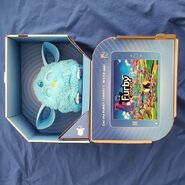 A blue Furby Connect in its box