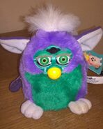 A Very Purple Furby Baby with neon green eyes