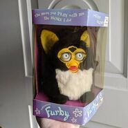 An NIB english Penguin Furby with the KB Toys sticker