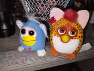 A shaking pocket pet next to a McFurby