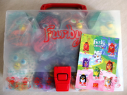 A case of McFurby keychains with a red handle