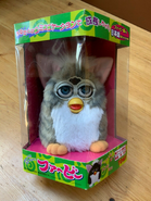 A japanese church mouse Furby in its box