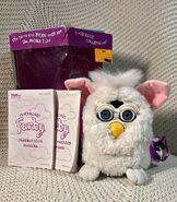A Snowball Furby with its box that was bought from Toys R Us.