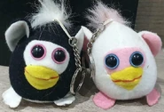 A black and white Shaking Pocket Pet with a white and pink one