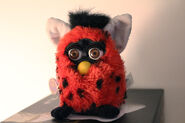 A Ladybug Furby with brown eyes (photo by @angel-nee on Tumblr)