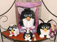 A Skunk-themed Talking Keychain, Furby, Tootsie Roll Necklace, and Furby Buddy.