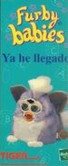 A part of a Spanish Furby Babies advertisement featuring a Purple Tip Furby Baby.