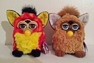 A Rusty Dots Furby besides a Labrador Furby