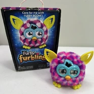 A Pink Cubes Furbling next to its box