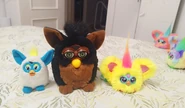 A Gorilla Furby alongside Nug-Ette and a 2012 McFurby