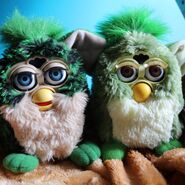 A Turtle Furby next to a Frog Furby