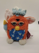 A Patriotic Furby with white eyelashes