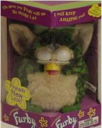 A boxed Turtle Furby with its eyes closed