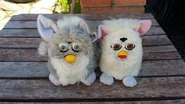 A gray Foobie next to a Snowball Furby