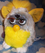 A Banana Peel Furby with brown eyes
