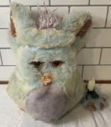 Cotton Candy Furby with its foot broken off
