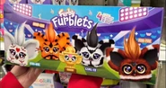 Side of the (24 Furblets) Sport Furblets case, showing illustrations of the Furblets in a stadium and an exclusive Throphy Mini