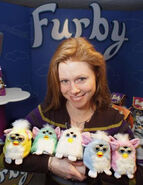 Toy fair presenter, Heather Witbeck, holding some prototype Furby Babies