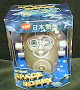 A gold Space Robby in its box