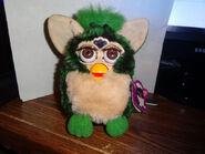 A Turtle Furby with brown eyes.