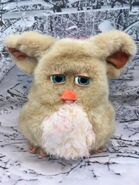A Sand Emoto-Tronic Furby with a worn beak