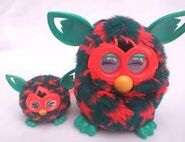 Orange Stars Furby next to its Furbling