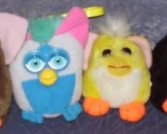 A McDonald's Furby keychain and a Mini Loobie next to it.