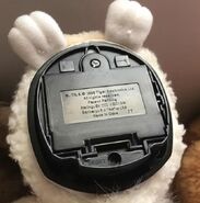 The underneath of a Lamb Furby showing the factory code "JT".