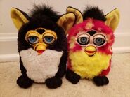 A Penguin Furby next to a Rusty Dots Furby