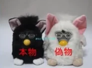 a white foobie next to a Witch's Cat Furby
